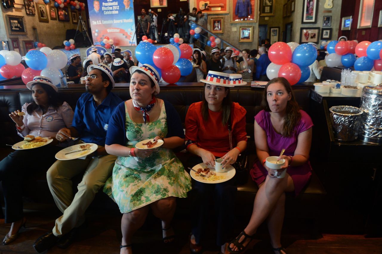 U.S. citizens and other guests watch election results on a giant TV screen Wednesday in Mumbai.