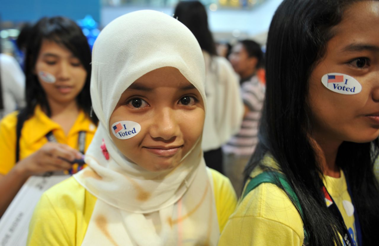 Philippine students in Manila decorate their faces with election stickers during a mock vote spearheaded by the U.S. Embassy on Wednesday.