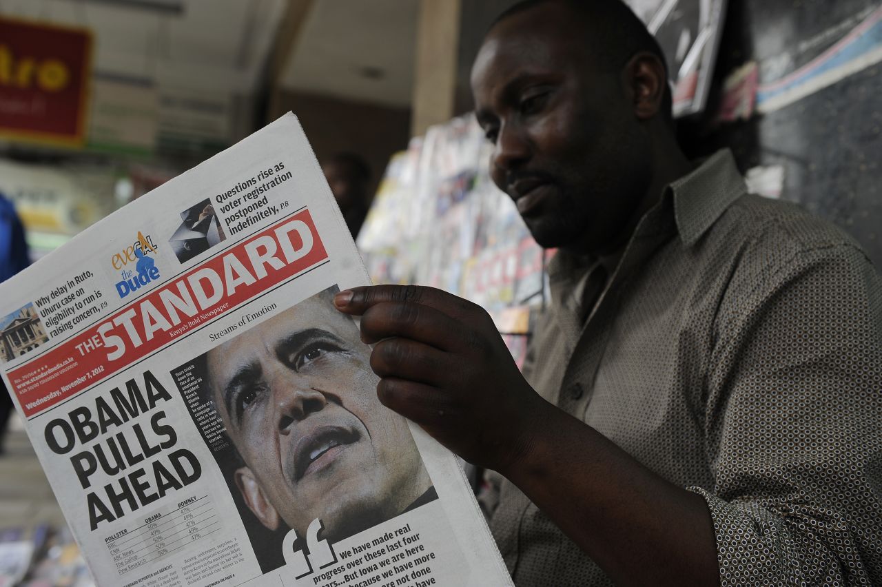 A Kenyan in Nairobi reads the The Standard newspaper headlining Obama's re-election on Wednesday. 