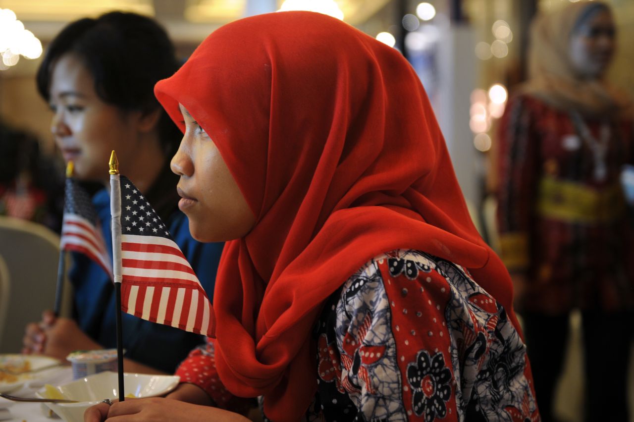 Indonesian student Anisa Widya Lestari, 20, holds a U.S. flag while watching election returns at a poll monitoring center set up by the U.S. Embassy in Jakarta on Wednesday, November 7. President Barack Obama spent some of his early childhood in the Indonesian capital.