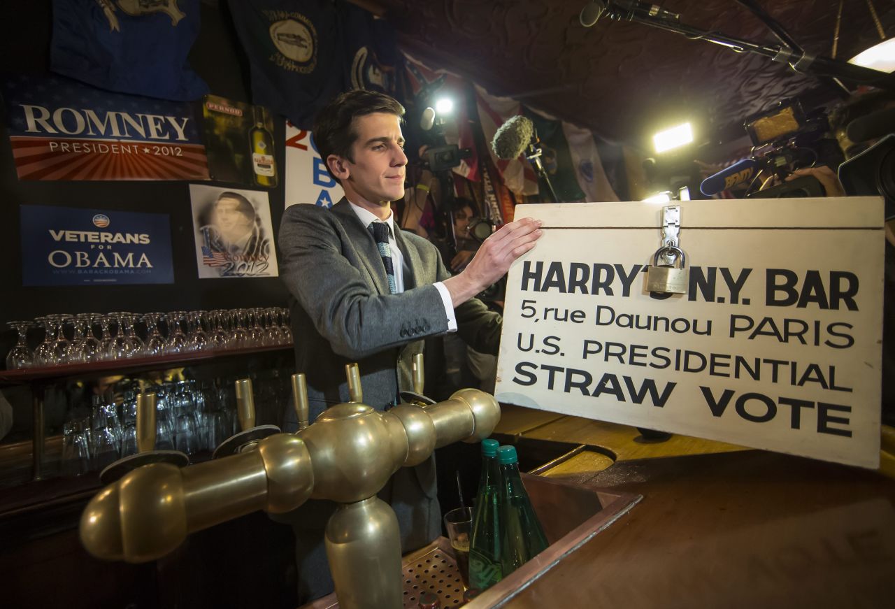 A staffer at Harry's New York Bar in Paris prepares to count mock ballots from a straw vote held Tuesday at the bar for U.S. expats. 