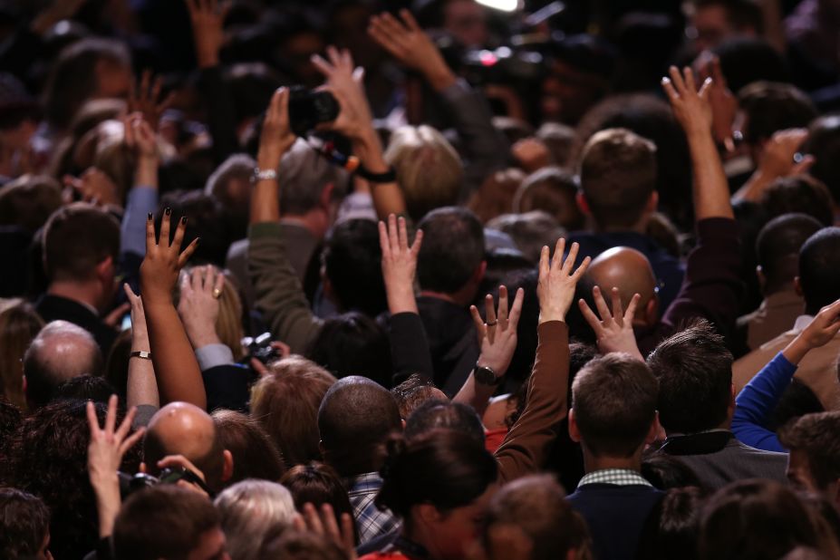 Obama supporters raised their hands in victory at an election night watch party in Chicago.  