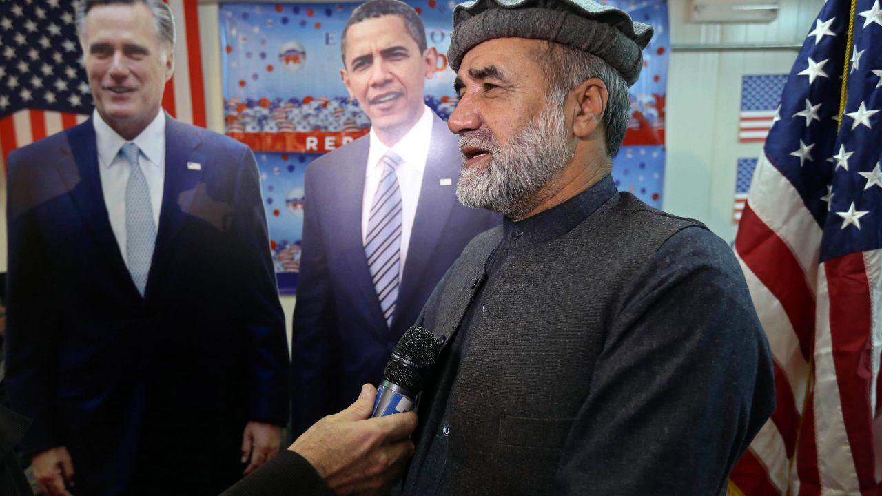 Afghan journalist Abdul hai Warshan is interviewed in front of cardboard cutouts of U.S. President Barack Obama and Republican presidential candidate Mitt Romney at the U.S. embassy in Kabul, Afghanistan.