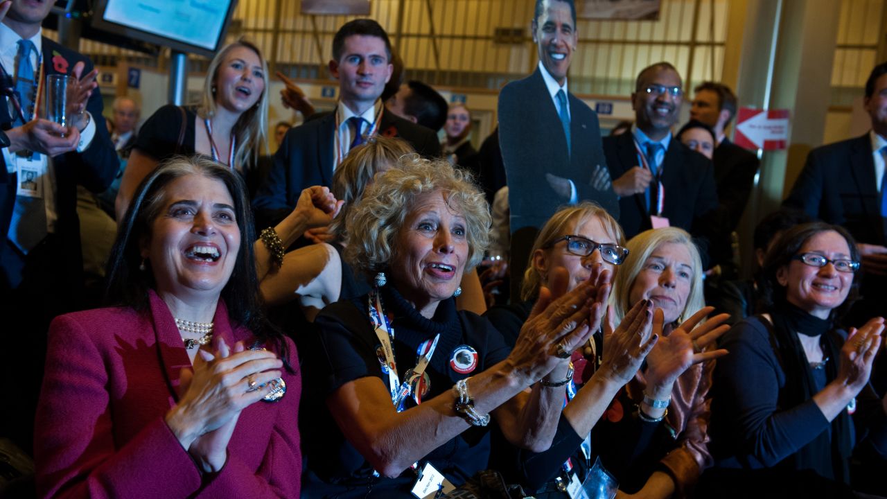Obama supporters react as they watch a television screen during an election viewing party at the U.S. Embassy in London, England.