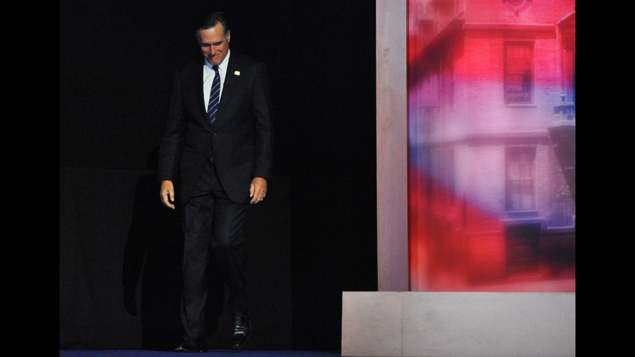Republican candidate Mitt Romney hung his head and smiled as he strode onto the stage to give his concession speech. 