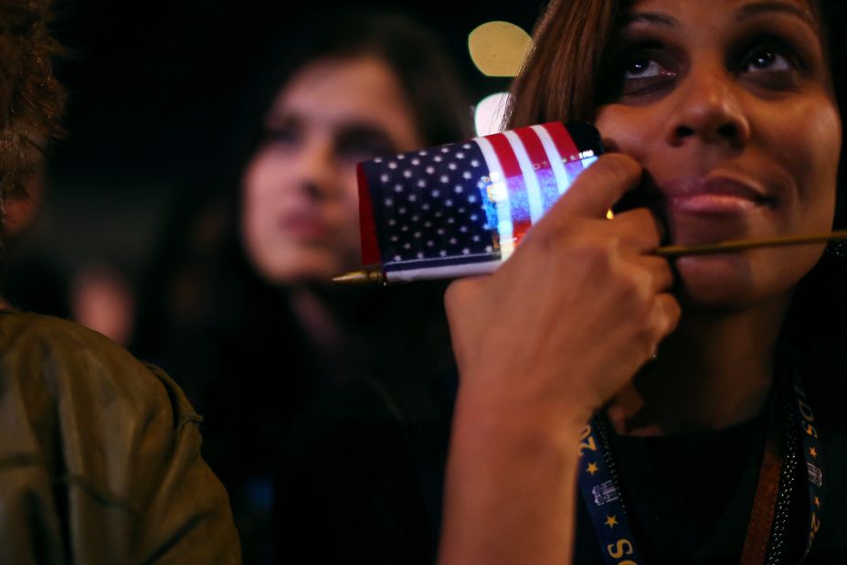 An Obama supporter clutched a flag and a smart phone at an election night rally in Chicago.