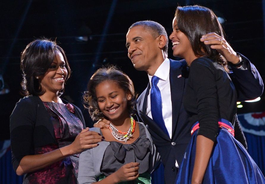 President Barack Obama embraced first lady Michelle Obama and daughters Sasha and Malia moments before he delivered a rousing victory speech.