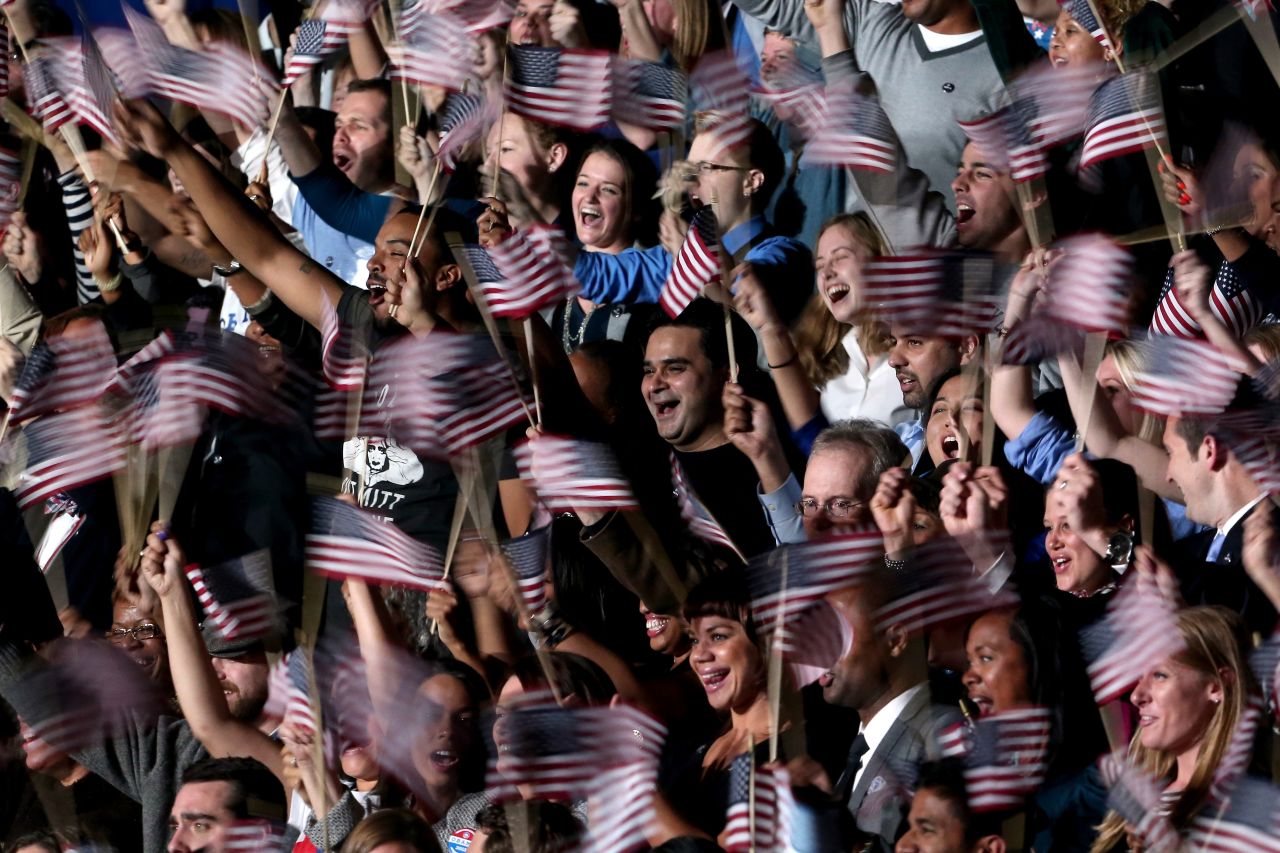 A blur of waving flags greeted President Barack Obama's victory speech at an election night event in Chicago, Illinois.