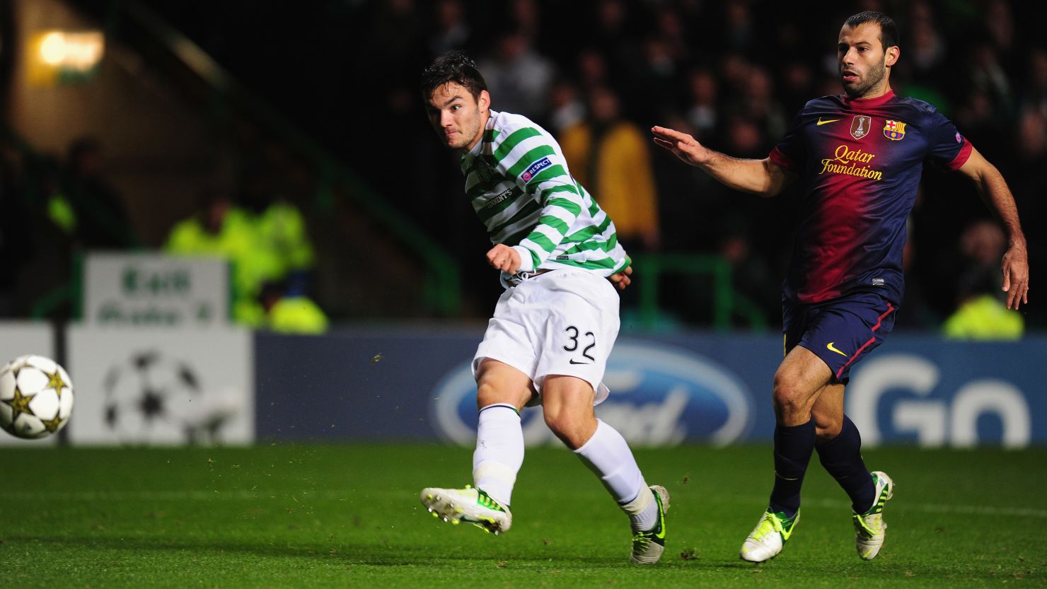 Teenage substitute Tony Watt scores Celtic's second goal as Barcelona's Javier Mascherano watches in Glasgow.