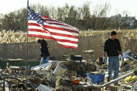 Friends and members of the Puglia family sift through the remains of their missing home for valuables on November 6, 2012, after Hurricane Sandy hit Staten Island, New York.  <a href="http://www.cnn.com/2012/10/29/us/gallery/ny-braces-sandy/index.html">View photos of New York preparing for Sandy.</a>