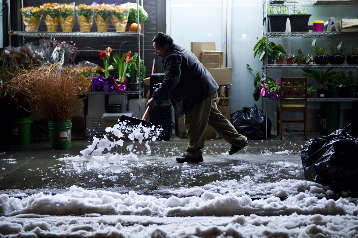 A man shovels snow dropped by a nor'easter on the Lower East Side of Manhattan on Thursday, November 8.