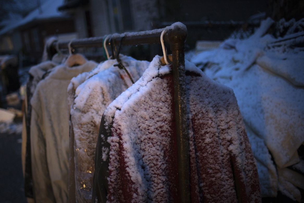 Snow covers clothes hanging outside a home that was destroyed by Sandy in Staten Island, New York, on Wednesday. 