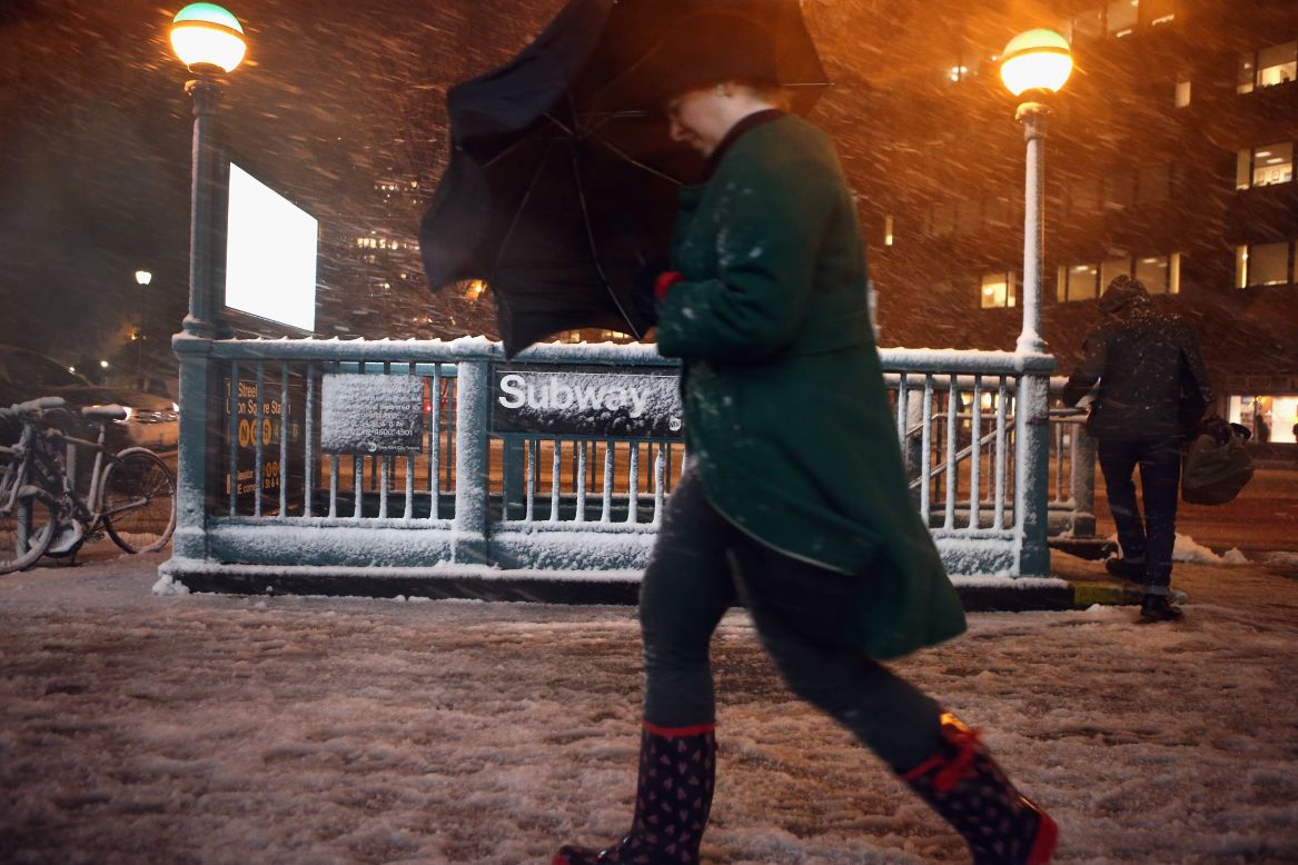 Pedestrians walk through high winds and snow near Union Square on Tuesday, November 6,  in New York.