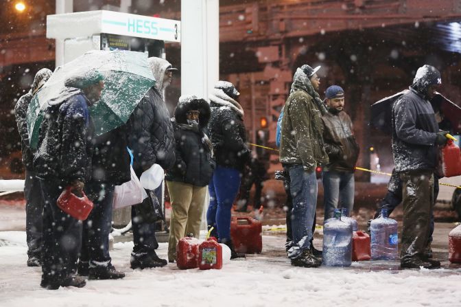 People wait in line to buy gasoline during the snowstorm on Wednesday night in  Brooklyn. The city is still short on gas because of Superstorm Sandy. 