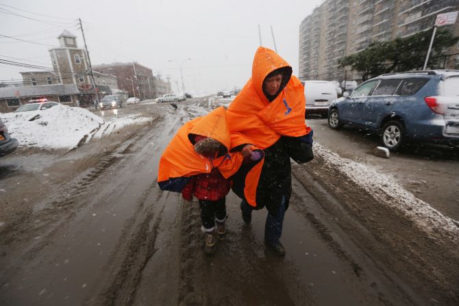 Fatima Quentiro and her granddaughter Galalea Castro trudge in the nor'easter snow and wind to a bus stop in the Rockaway neighborhood of Queens, New York, on Wednesday, November 7. Castro's home was damaged by flooding during Superstorm Sandy.  The Rockaway Peninsula was hit especially hard by Superstorm Sandy.
