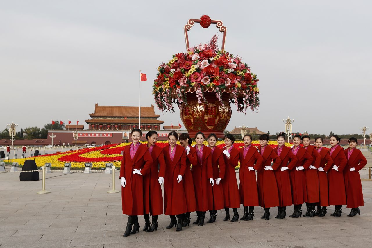 Attendants pose for a picture in Tiananmen Square on November 7.