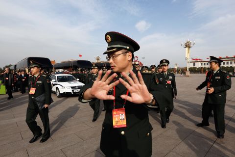 A soldier tries to prevent photos being taken in Tiananmen Square on November 7.