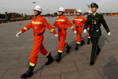 Chinese paramilitary policemen march through Tiananmen Square on November 7.