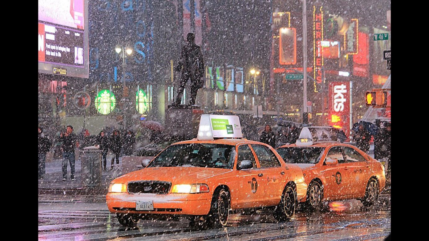 Cabs and pedestrians navigate the snow from a nor'easter falling in Manhattan on Wednesdayin this photo taken by<a href="http://ireport.cnn.com/docs/DOC-877979" target="_blank"> CNN iReporter Edgar Alan Zeta Yap</a>.