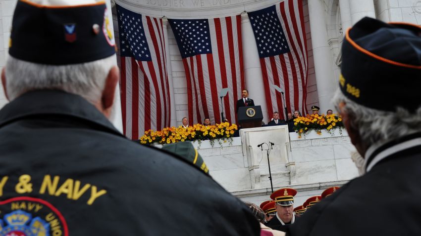 Veterans watch as President Barack Obama speaks at the Memorial Amphitheater after taking part in a wreath-laying ceremony on Veterans Day on November 11, 2011 at Arlington National Cemetery in Arlington, Virginia.