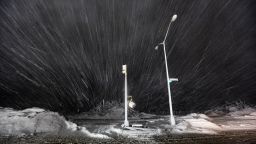 Snow blows past debris and nonfunctioning streetlights during a Nor'easter snowstorm on November 7, 2012 in the Rockaway neighborhood of the Queens borough of New York City. The Rockaway Peninsula was especially hard hit by Superstorm Sandy and some are evacuating ahead of the coming storm. 