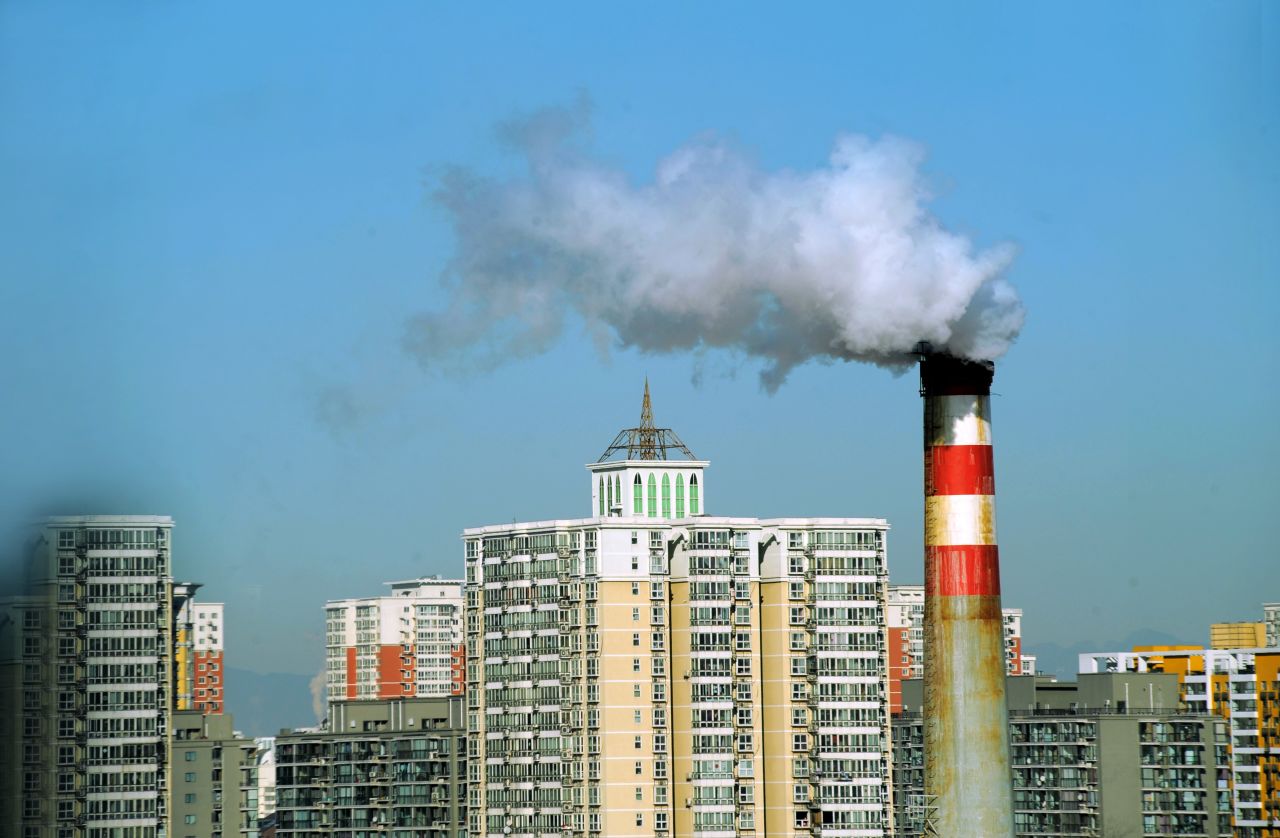 China relies on coal for 70-80% of its electricity needs, for everything from factories to winter heating, according to various experts. This photo taken in March 2011 shows pollutants billowing out of a chimney amid a group of residential housings in Beijing.