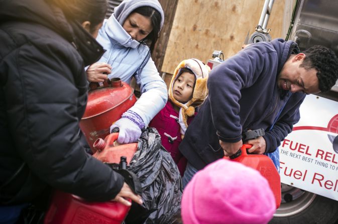 Residents try to stay warm while waiting for gas. 