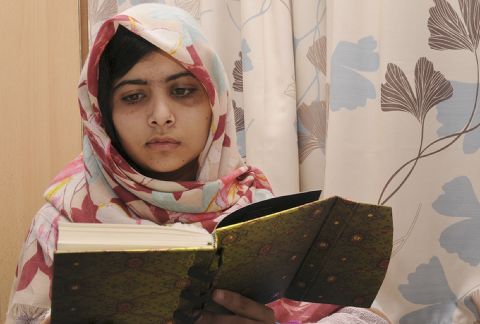Malala Yousufzai, 15, reads a book on November 7, 2012 at the hospital.