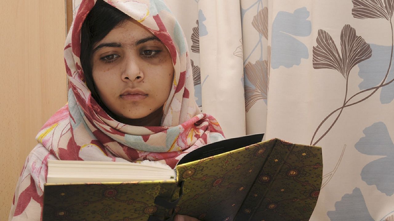 A handout picture taken on November 7 shows injured 15 year-old Pakistani schoolgirl Malala Yousafzai reading a book at the Queen Elizabeth Hospital in Birmingham, England.