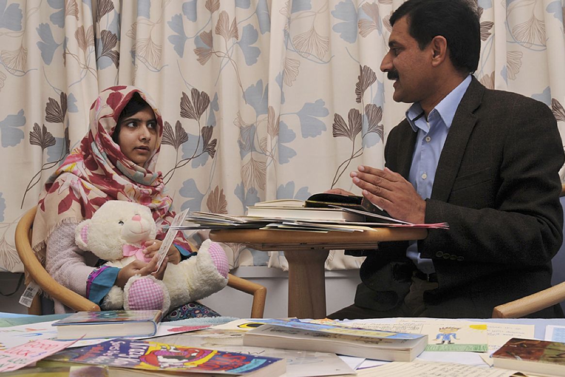Malala talks with her father, Ziauddin. She was attacked for advocating for girls' education in Pakistan.