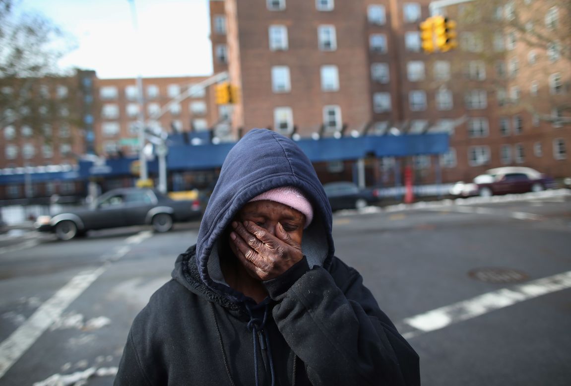 Theresa Goddard, her apartment still without electricity, is overwhelmed while discussing her living conditions on Thursday, November 8, in the Brooklyn borough of New York.