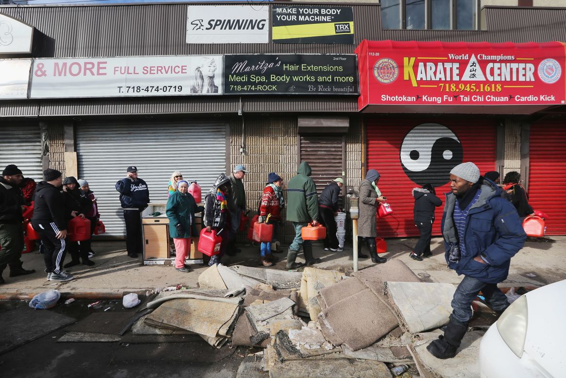 Residents wait in line to collect free gasoline the day after the nor'easter in the Rockaway neighborhood in Queens.