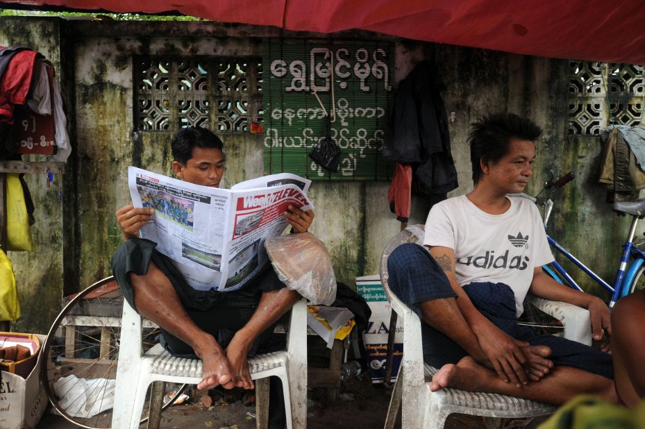 A  man reads a local newspaper after the government announced it had abolished media censorship on August 20, in the latest of a series of rapid democratic reforms, delighting journalists who lived for decades under the shadow of the censors.