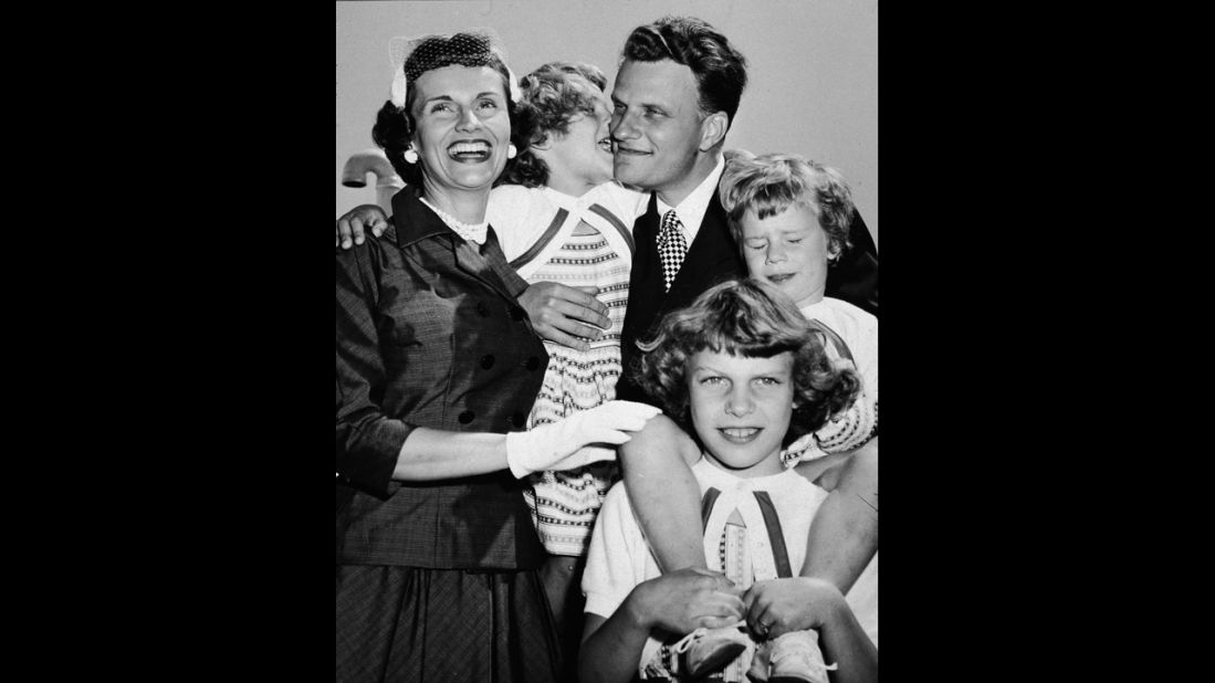 Graham embraces his family upon his return from his "Crusade for Christ" tour in the 1950s. With him from left are his wife, Ruth, and his daughters Anne, Virginia and Ruth (Bunny).
