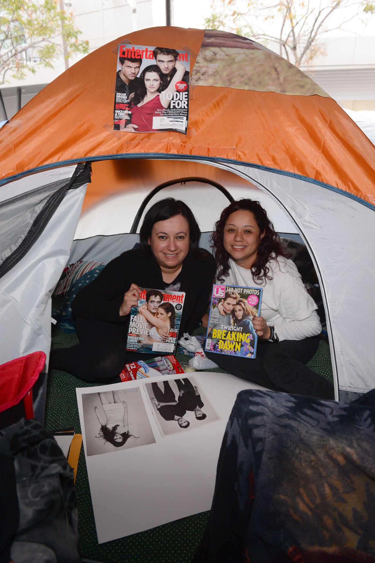 Fans hold up magazines featuring "Twilight" actors Robert Pattinson and Kristen Stewart.