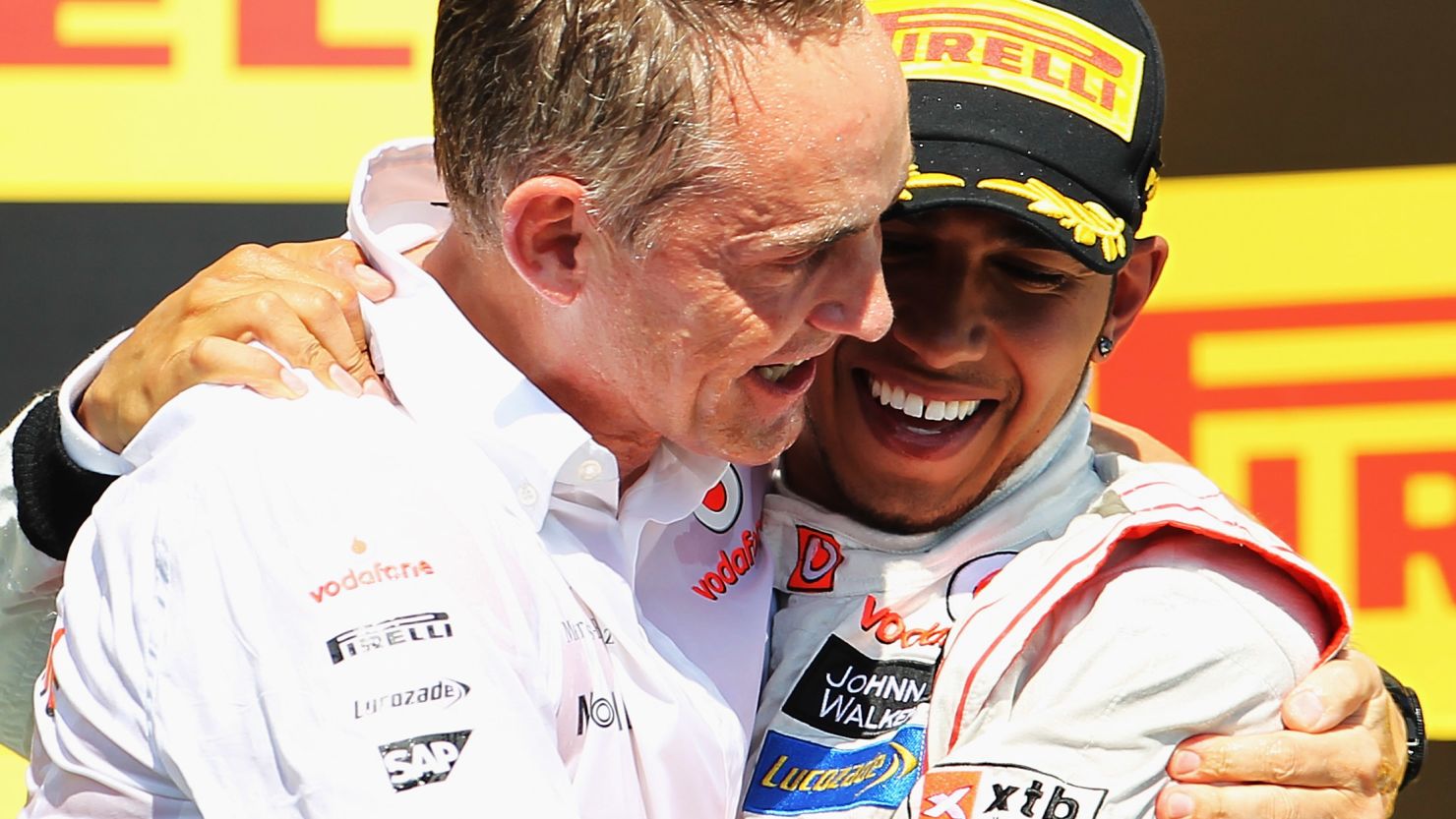 Happier times: Martin Whitmarsh (left) celebrates with Lewis Hamilton after he won this season's Canadian Grand Prix.