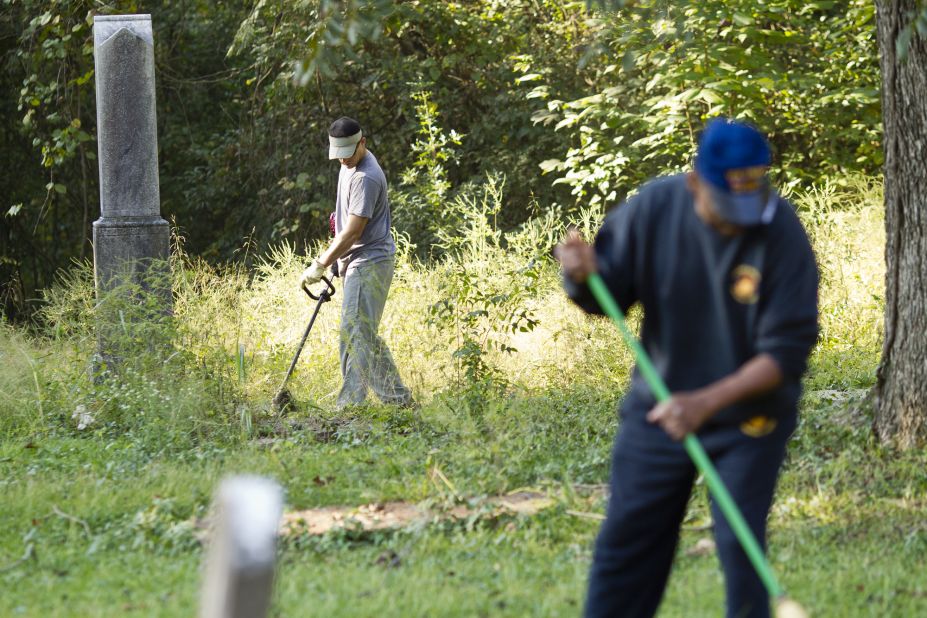 Volunteers clear the overgrown brush from Linwood Cemetery, which tells the story of Macon's African-American community. Sgt. Rodney Davis' mother insisted on burying him there, instead of Arlington National Cemetery.  Davis' sister, Debra Ray said: "Mother would say if Rodney wasn't there nobody would care about the cemetery." 