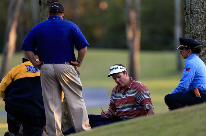 Beljan speaks with emergency medical services staff during his second round at the Magnolia course on Friday.