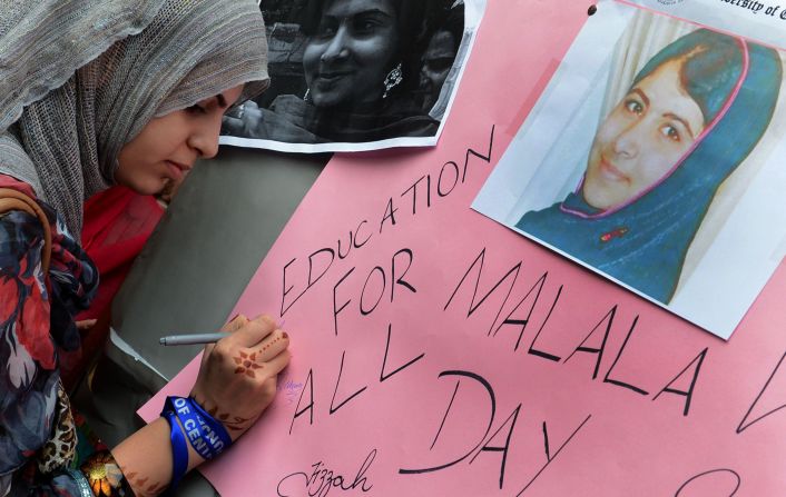 A Pakistani student in Lahore writes a message on a placard on Saturday.