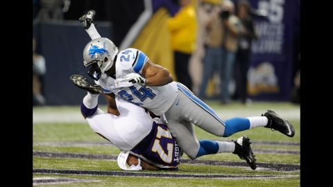Erik Coleman of the Lions brings down Jarius Wright of the Vikings during the first quarter of Sunday's game.