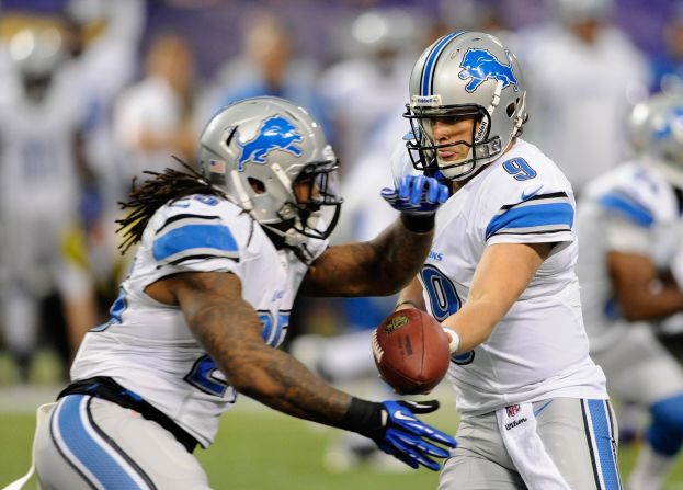 No. 9 Matthew Stafford of the Detroit Lions hands off the football to No. 25 Mikel Leshoure during the first quarter of the game against the Minnesota Vikings on Sunday at the Hubert H. Humphrey Metrodome in Minneapolis, Minnesota.