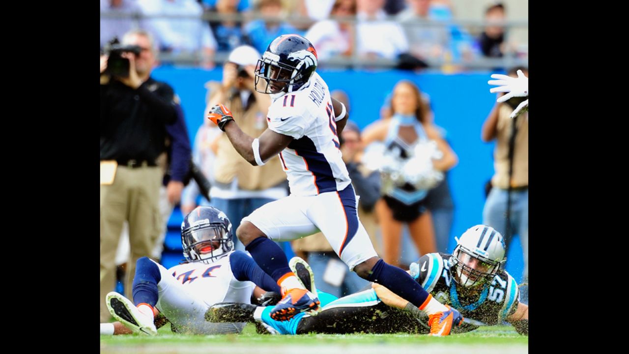 Trindon Holliday of the Denver Broncos breaks away from Jordan Senn of the Carolina Panthers as he takes a punt return back for a touchdown at Bank of America Stadium on Sunday in Charlotte, North Carolina.