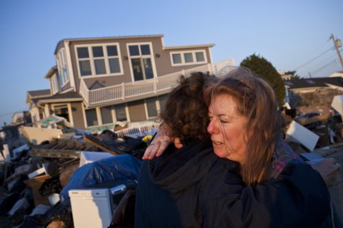 Evelyn Faherty hugs a friend on Sunday, November 11,<strong> </strong>while discussing the damage done to her home by Superstorm Sandy in the Breezy Point neighborhood of Queens, New York.