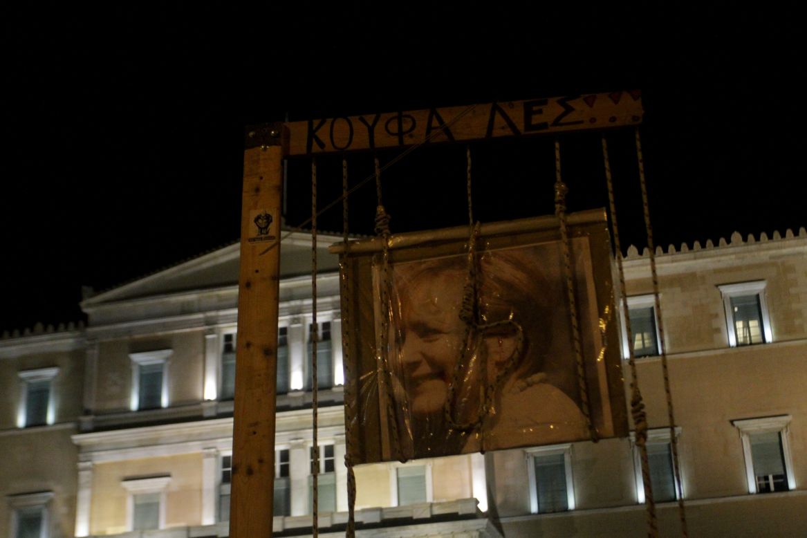 A portrait of German Chancellor Angela Merkel is roped and hung outside the Greek Parliament during a protest against austerity measures in Athens on November 11, 2012.