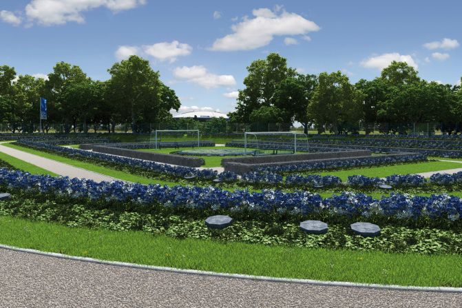 The Schalke Fan Feld, whose centerpiece will be a club logo made up of blue and white flowers lying between two goals, looks directly on to the Bundesliga club's home stadium - the white domed Veltins-Arena, which can be seen in the gap between the trees in this picture. 