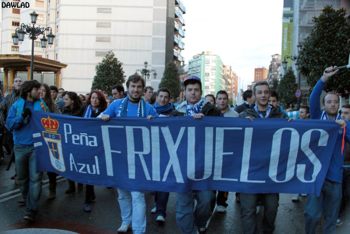 Real Oviedo fans hold up banner as they march through the city on their way to the league match to protest against the possible closure of the club due to financial difficulties.
