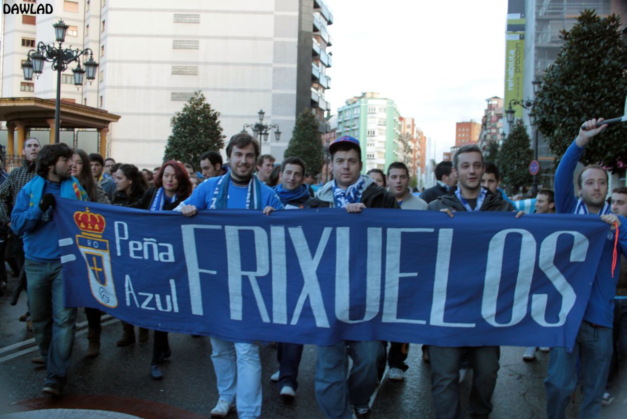 Real Oviedo fans hold up a banner as they march through the northern city on their way to the game.