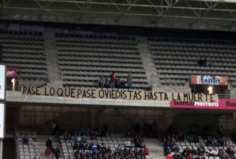 Oviedo fans display a banner in the Estadio Carlos Tartiere reading: "Happen what may, Oviedistas until death."