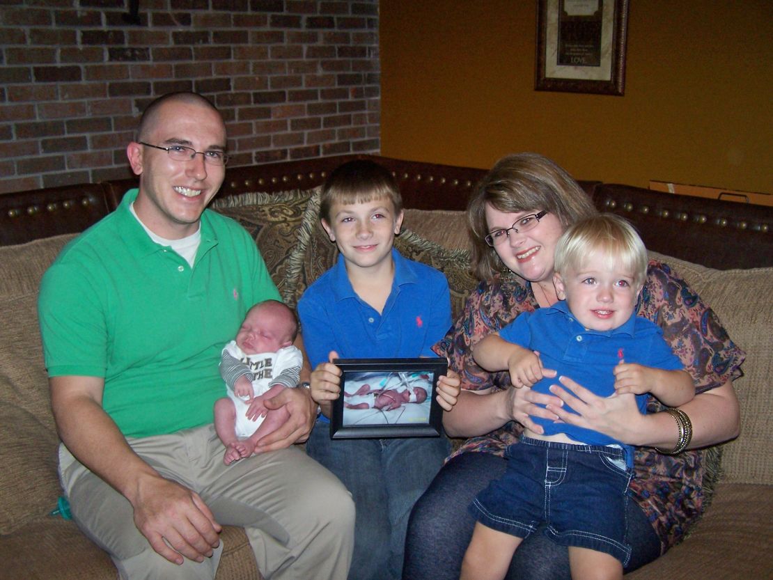 The Dykes family holds a photo of Jesse Ray, who was born prematurely and died in 2008.