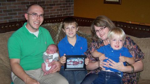 The Dykes family holds a photo of Jesse Ray, who was born prematurely and died in 2008.